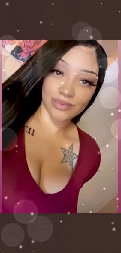 Woman with star tattoo in burgundy top.