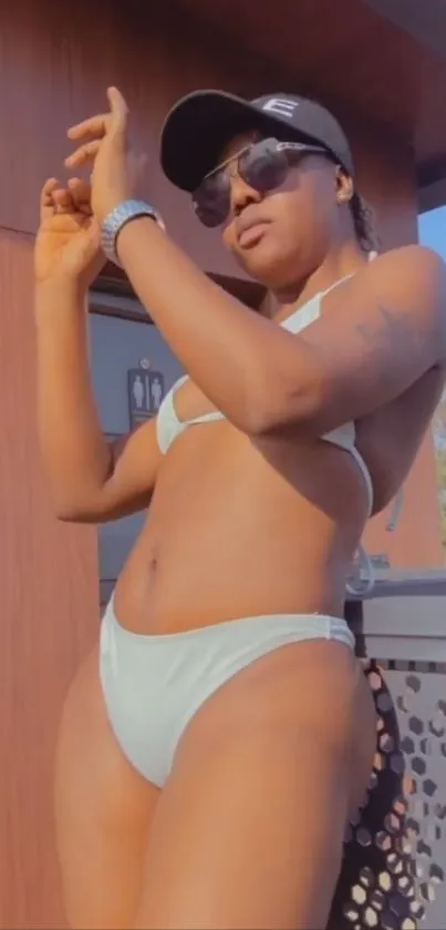 Woman in beachwear enjoying sunny outdoor setting.