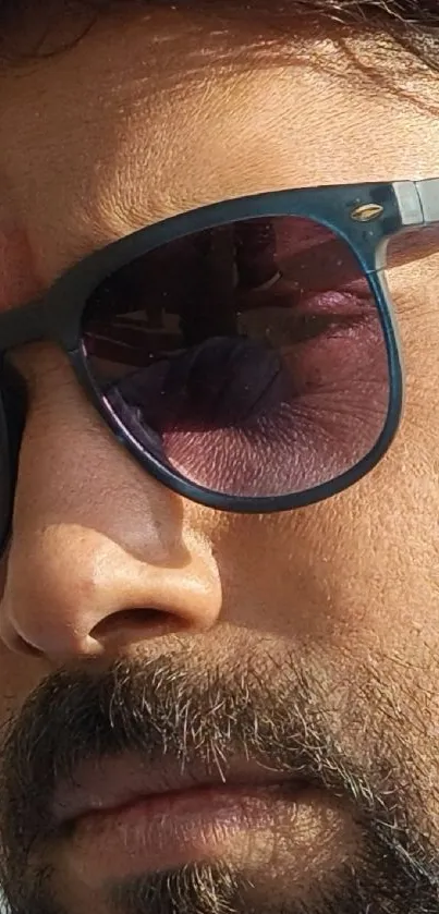 Close-up of stylish sunglasses on a face.