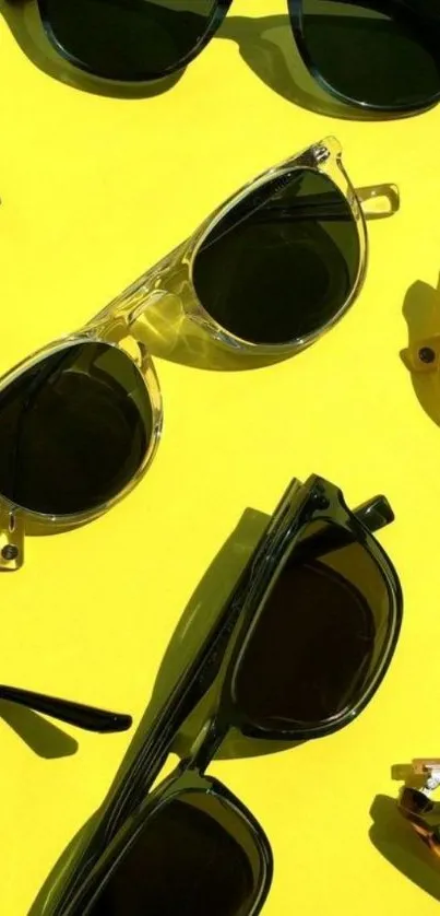 Stylish sunglasses scattered on a vibrant yellow background.