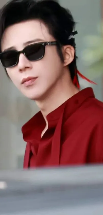 Stylish portrait with sunglasses, featuring a red outfit and modern appeal.