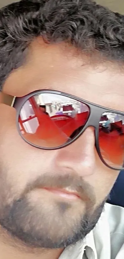 Man wearing stylish sunglasses with reflection.