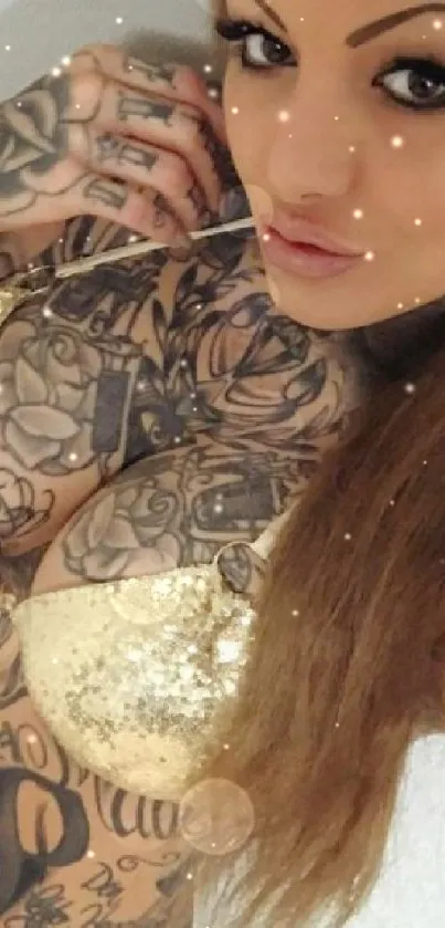 Tattooed woman with gold accents on mobile wallpaper.