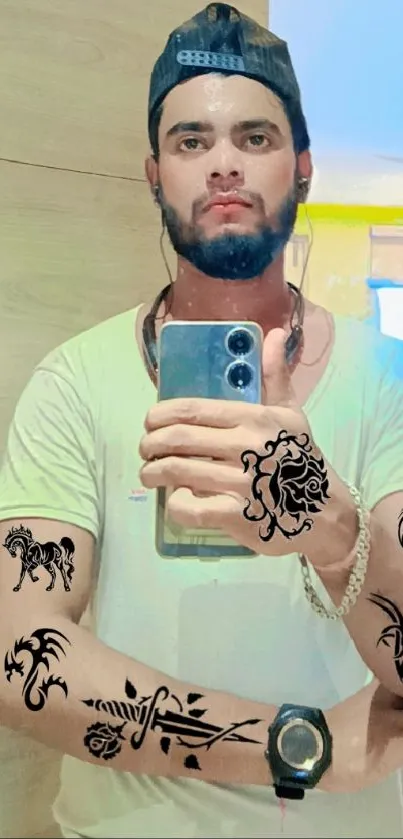 Mirror selfie with stylish tattoos and a cap.