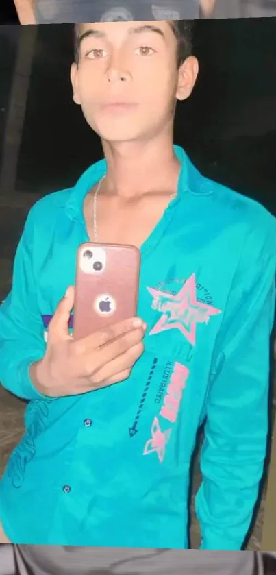 Young person in teal shirt taking a selfie with a red smartphone.