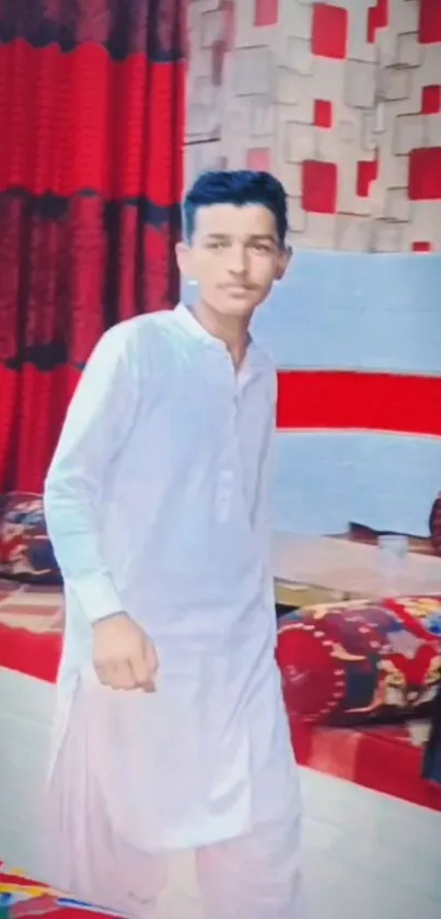 A person in traditional attire in a vibrant red interior.