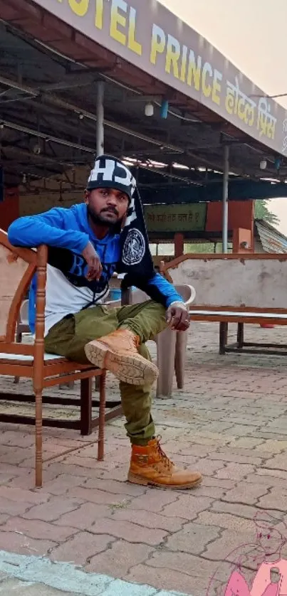 Stylish person sitting at rustic hotel backdrop.