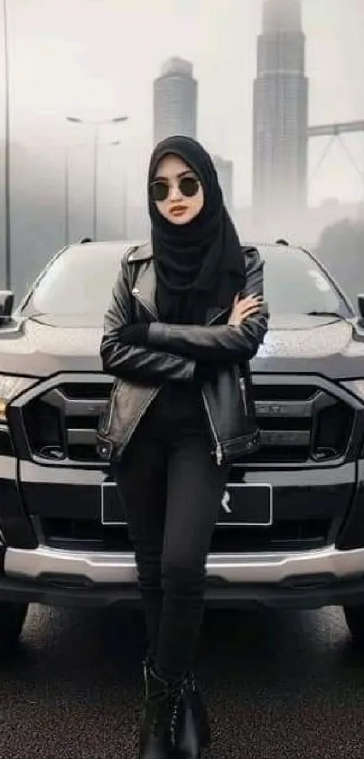 Person in black standing in front of car with cityscape backdrop.