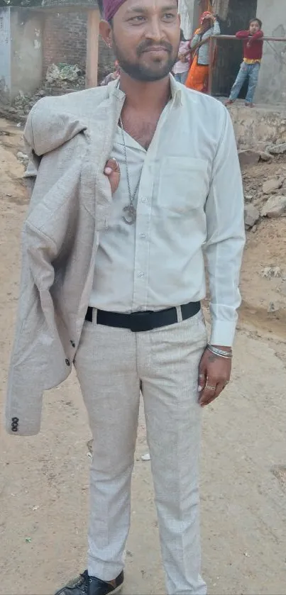 Man in light beige suit with urban background.