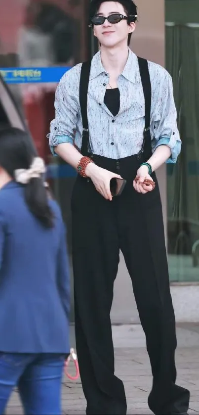 Young man in urban fashion with sunglasses and suspenders.