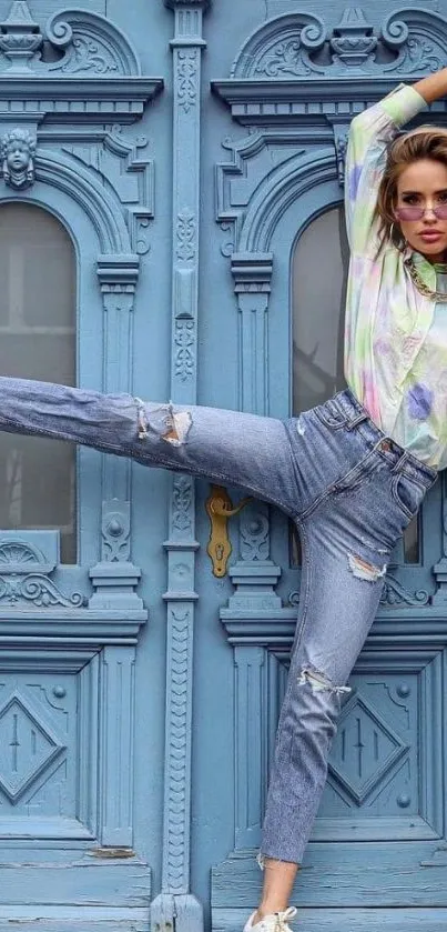 Model in denim against blue ornate door, stylish urban fashion wallpaper.