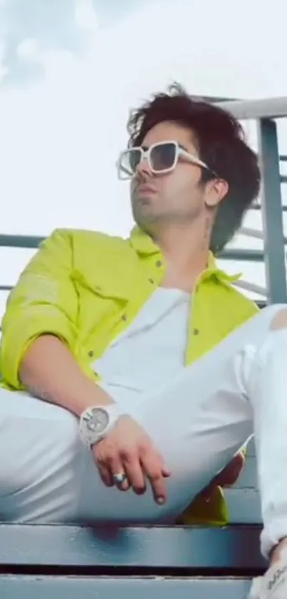 Person in neon outfit with sunglasses, stylish pose.