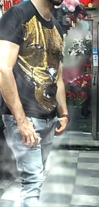 Man wearing a lion graphic black shirt in an urban setting.