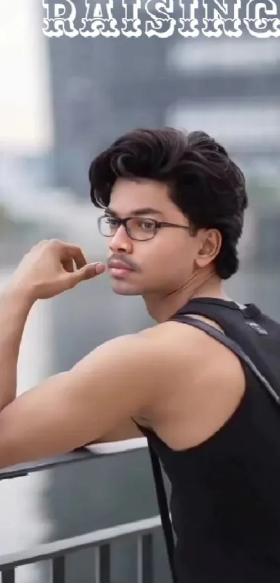 Stylish urban portrait of a man with glasses in a city setting.