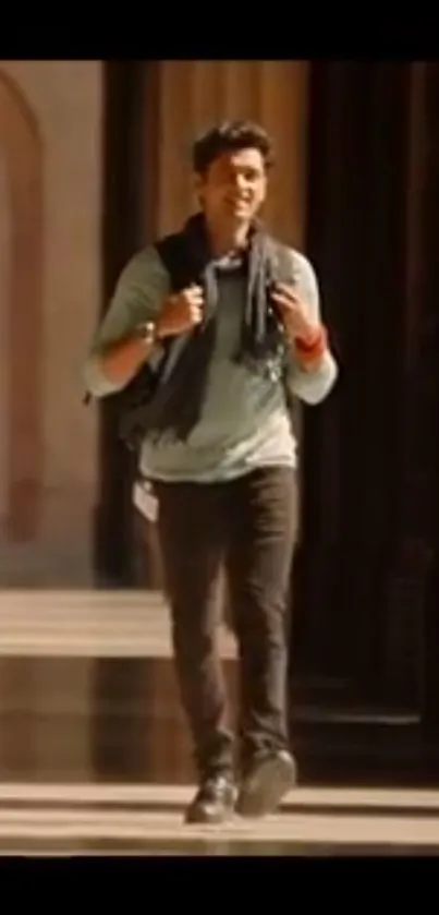 Man walking in sunlit corridor, stylish and modern.