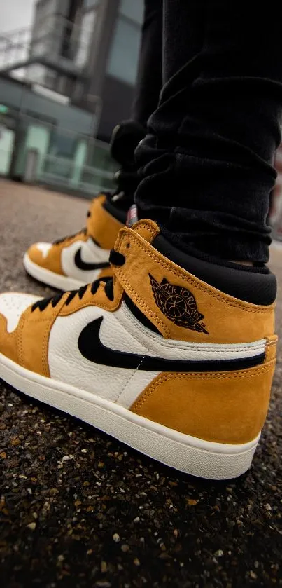 Tan and black sneakers on urban background.