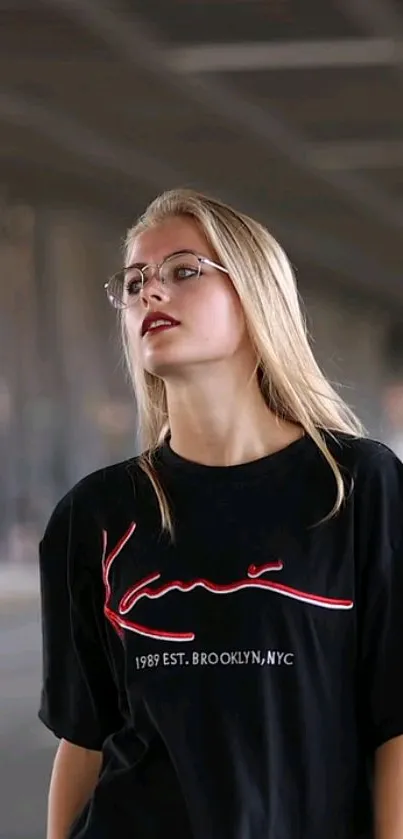 Woman in a black t-shirt with urban background wallpaper.