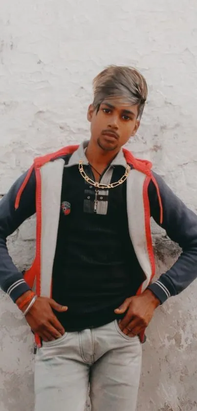 Stylish young man posing against a textured wall.