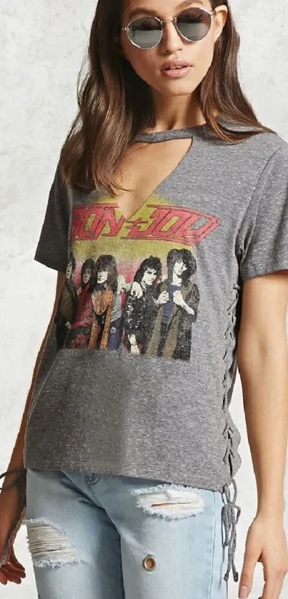 Woman wearing vintage band t-shirt with distressed jeans.