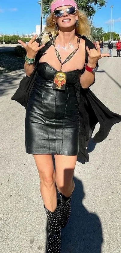 Woman in leather dress walking in urban street under blue sky.