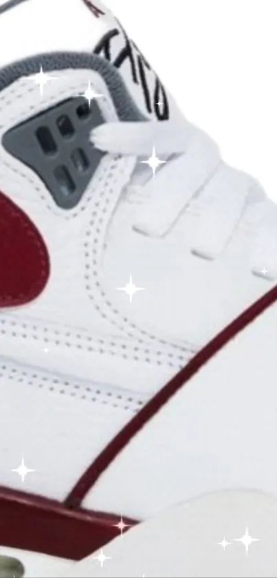 Close-up of a white sneaker with red details and sparkling effects.