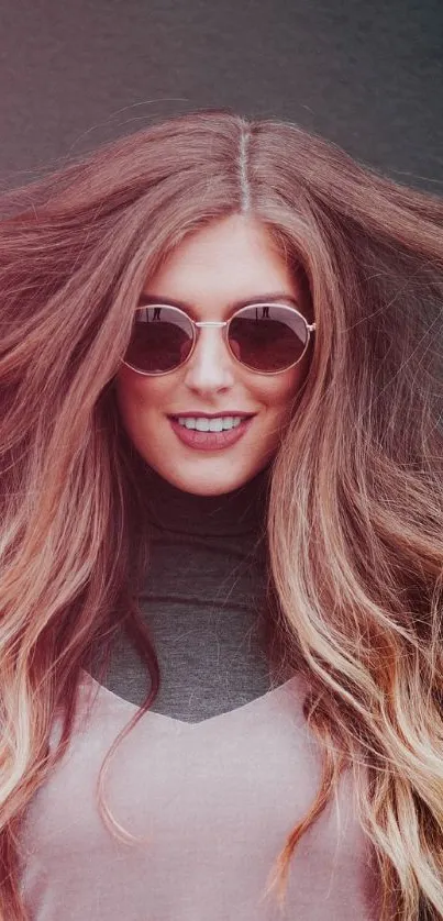 Woman with sunglasses and flowing hair in stylish mobile wallpaper.