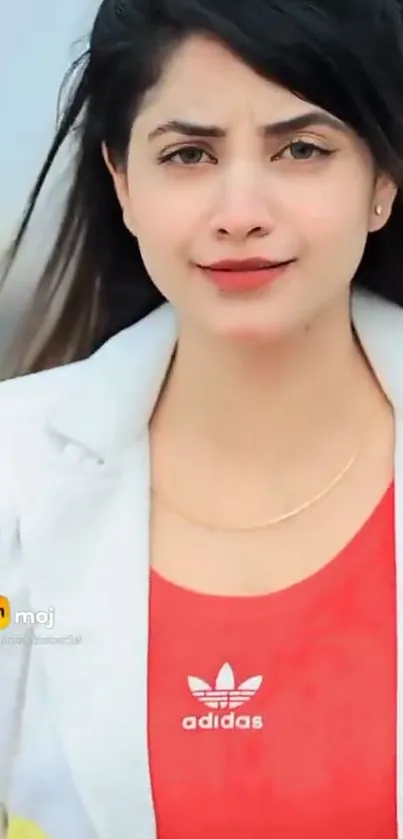 Woman in a white blazer and red top, stylish and modern.