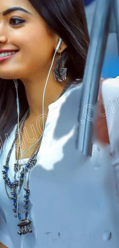 Woman smiling with headphones and stylish accessories.