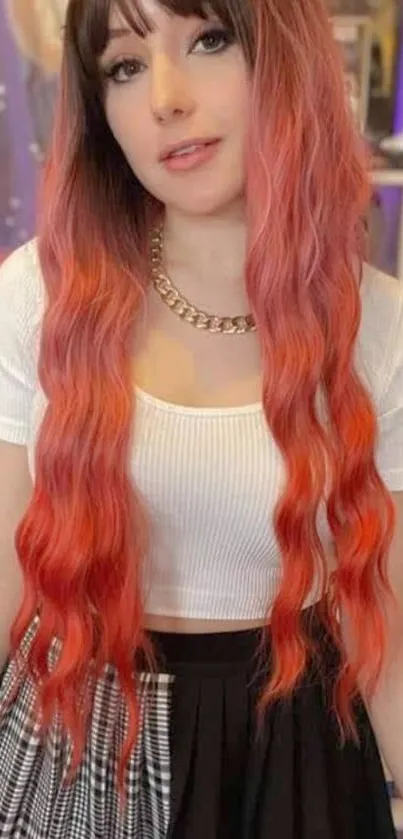 Woman with long, vibrant red hair and stylish attire.