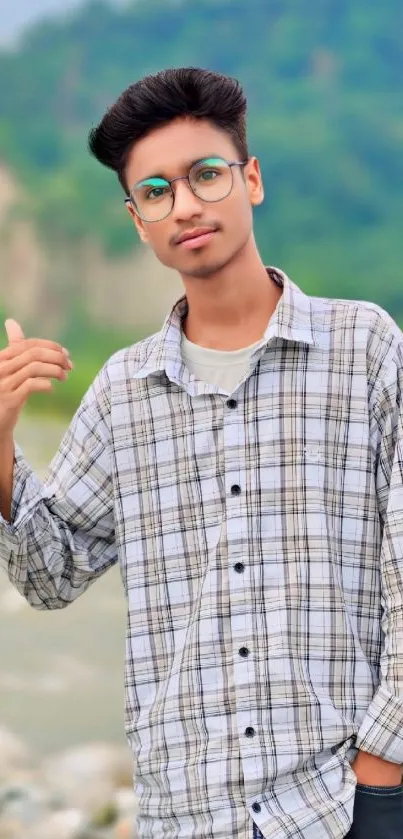 Young man in glasses with nature background.