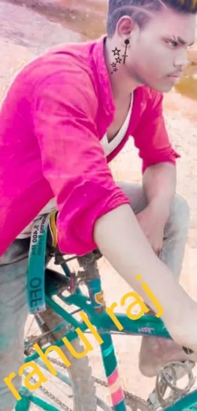 Young man in red shirt posing on a bicycle.