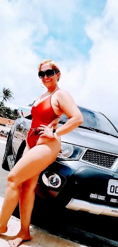 Woman in red bikini poses beside SUV on sunny beach.