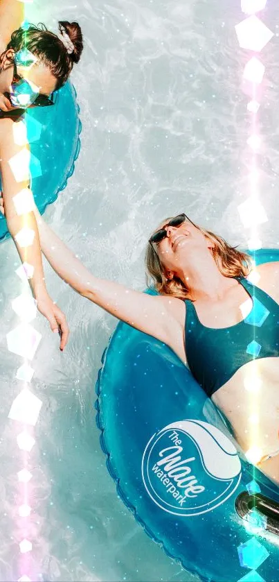 Two friends enjoying a sunny day on blue pool floats.