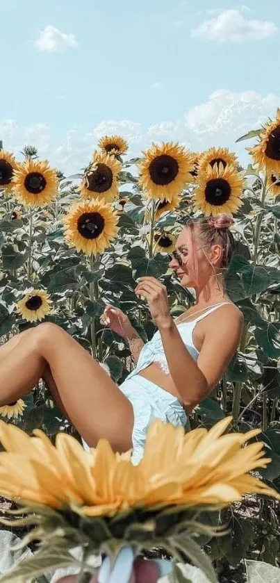 Woman relaxing in a vibrant sunflower field under a clear blue sky.