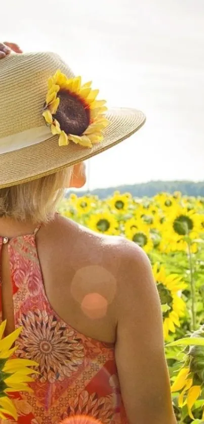 A woman with a hat standing in a vibrant sunflower field.