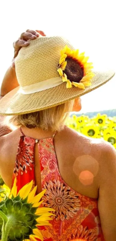 Woman in sunflower field wearing a straw hat.