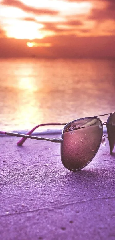 Sunglasses on a vibrant purple sunset beach.