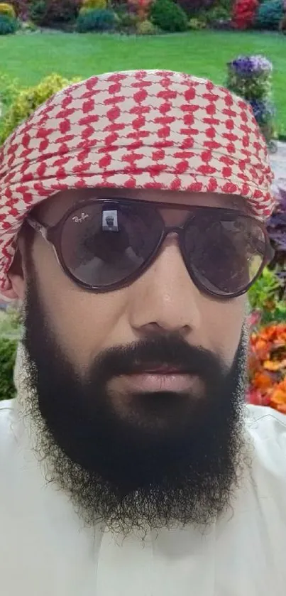 Man with sunglasses in a colorful garden