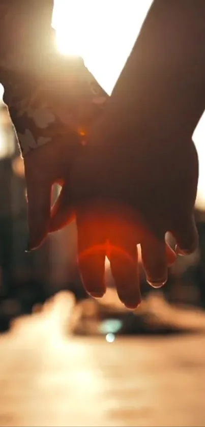 Romantic sunset with hands in warm, glowing light.