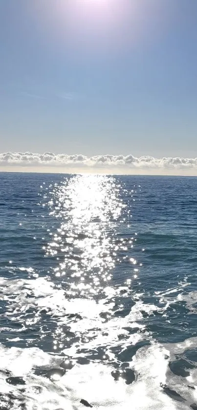 Sunlit ocean waves with bright sky.