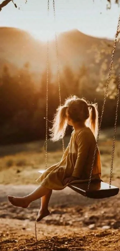 Child on swing during sunset with a peaceful landscape view.