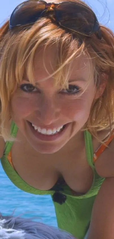 Woman smiling at the beach on a sunny day.