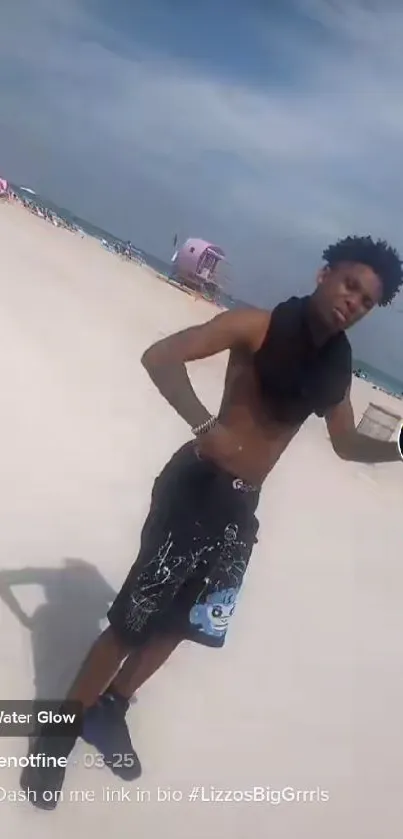 Man enjoying a sunny day on a sandy beach with a clear sky.