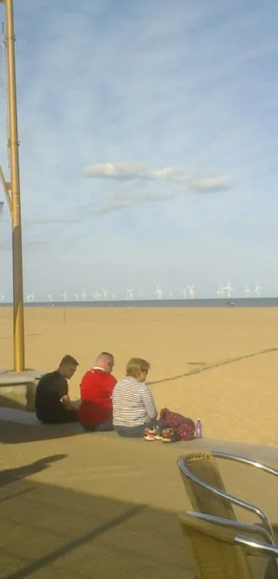 A sunny day at the beach with people relaxing by the ocean.