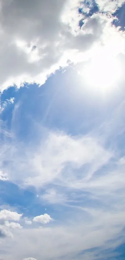 Bright blue sky with sunlight and white clouds in a tranquil view.