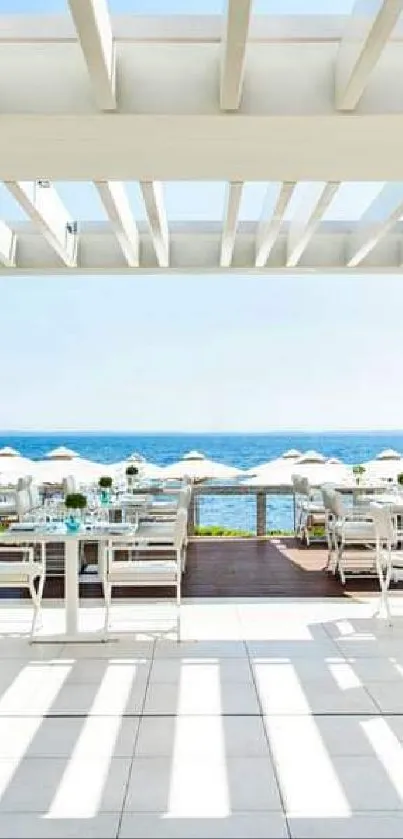 Sunny coastal terrace with ocean view and white decor.