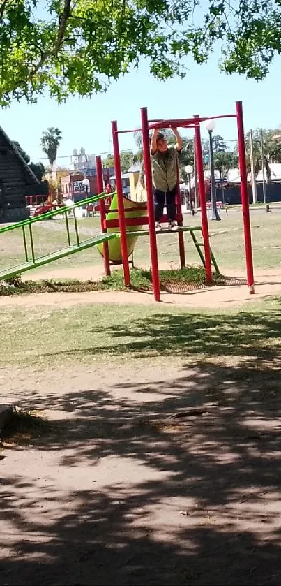 Child playing on playground equipment in a sunny park setting.