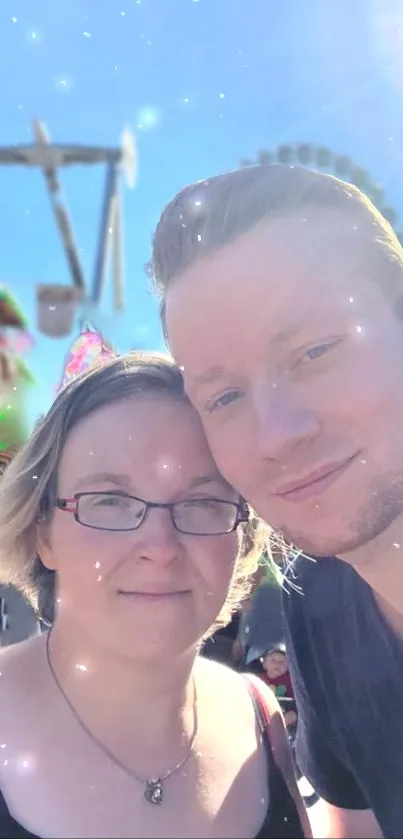 Couple enjoying a bright day at the carnival with sparkles in the background.