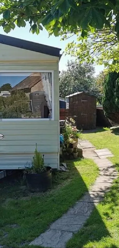 Mobile home in a sunny garden setting with green lawn.