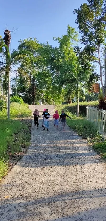 Children walking on a park pathway under a sunny blue sky.